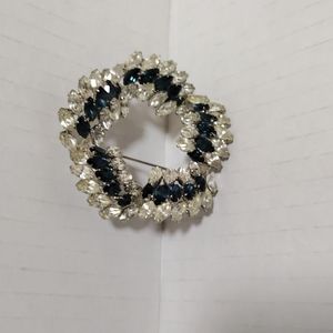 Silver tone vintage brooch pin with blue and white rhinestone